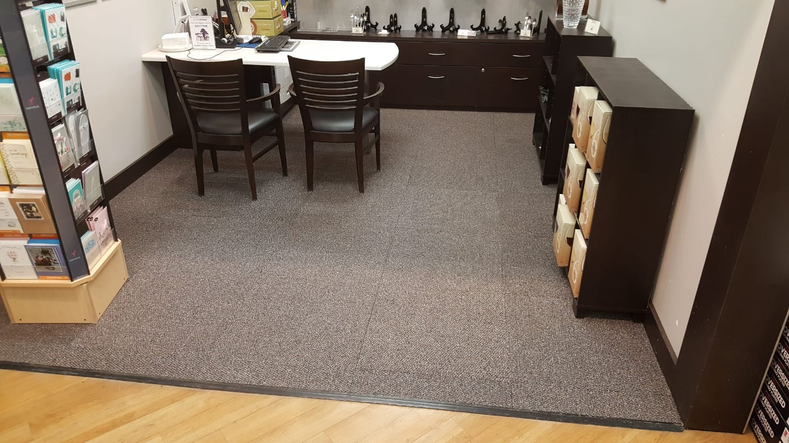 A finished retail interior with tables and shelving.